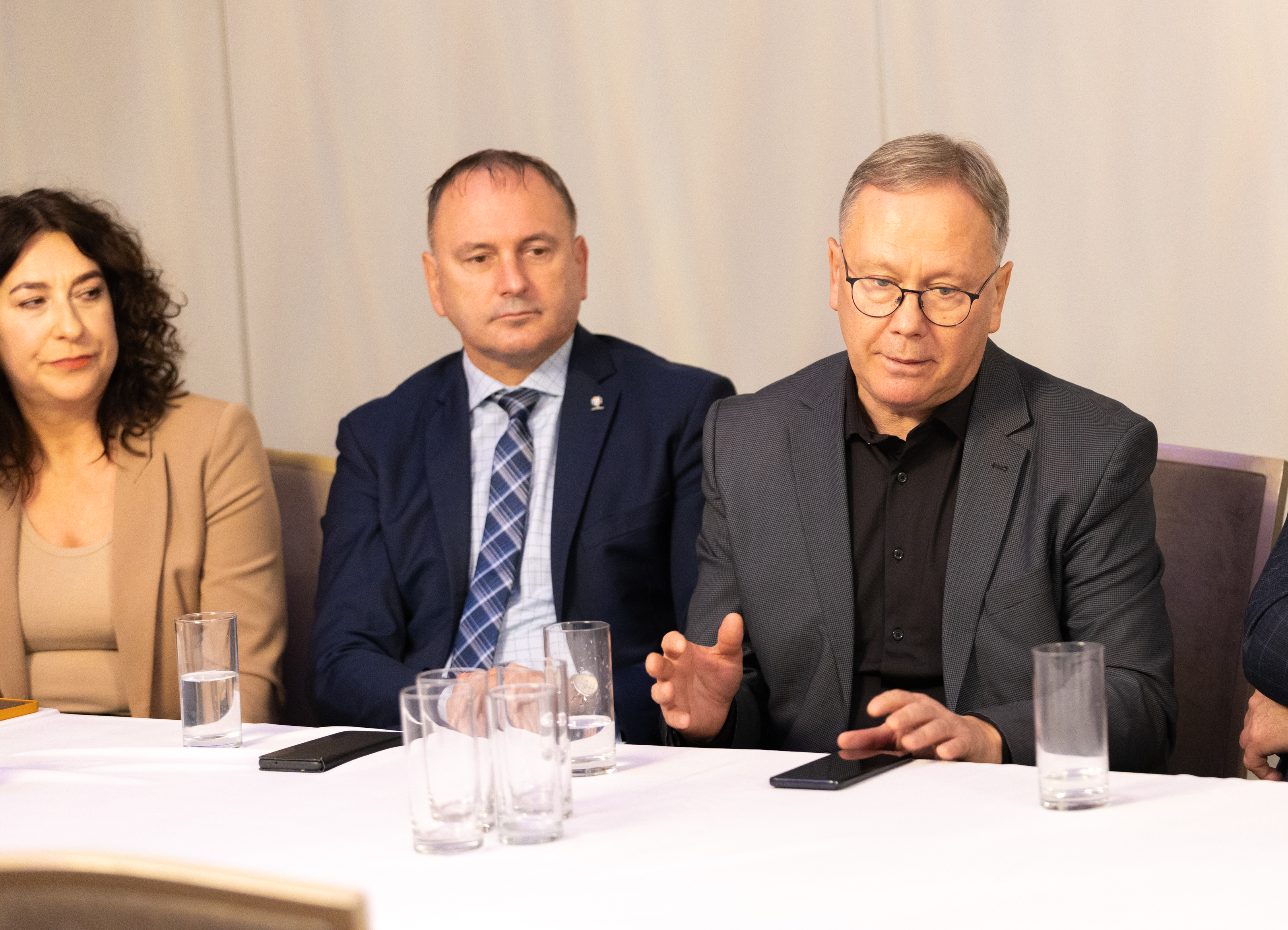 Kobieta i&nbsp;dw&oacute;ch mężczyzn przy stole