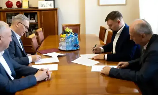 czterech mężczyzn w garniturach przy stole